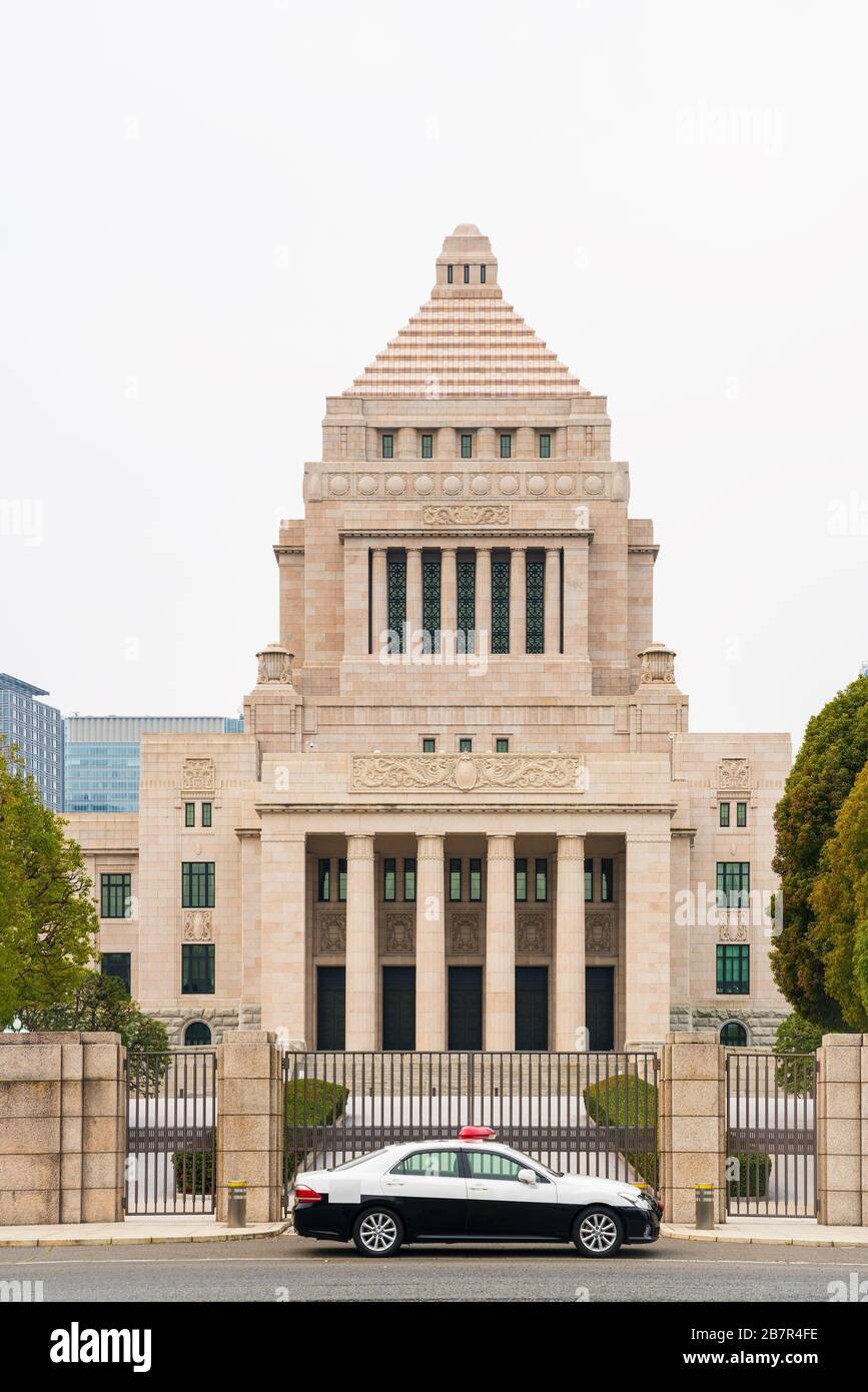 National diet building with a police car during in a cloudy day.  The National Diet Building is the building where both houses of the National Diet of Stock Photo