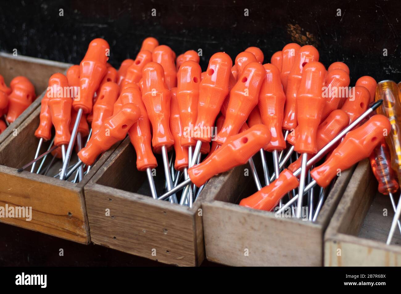 Screwdrivers at checkout in front of the store. Our red handle is stalked. It is unused and new. Close up. Stock Photo
