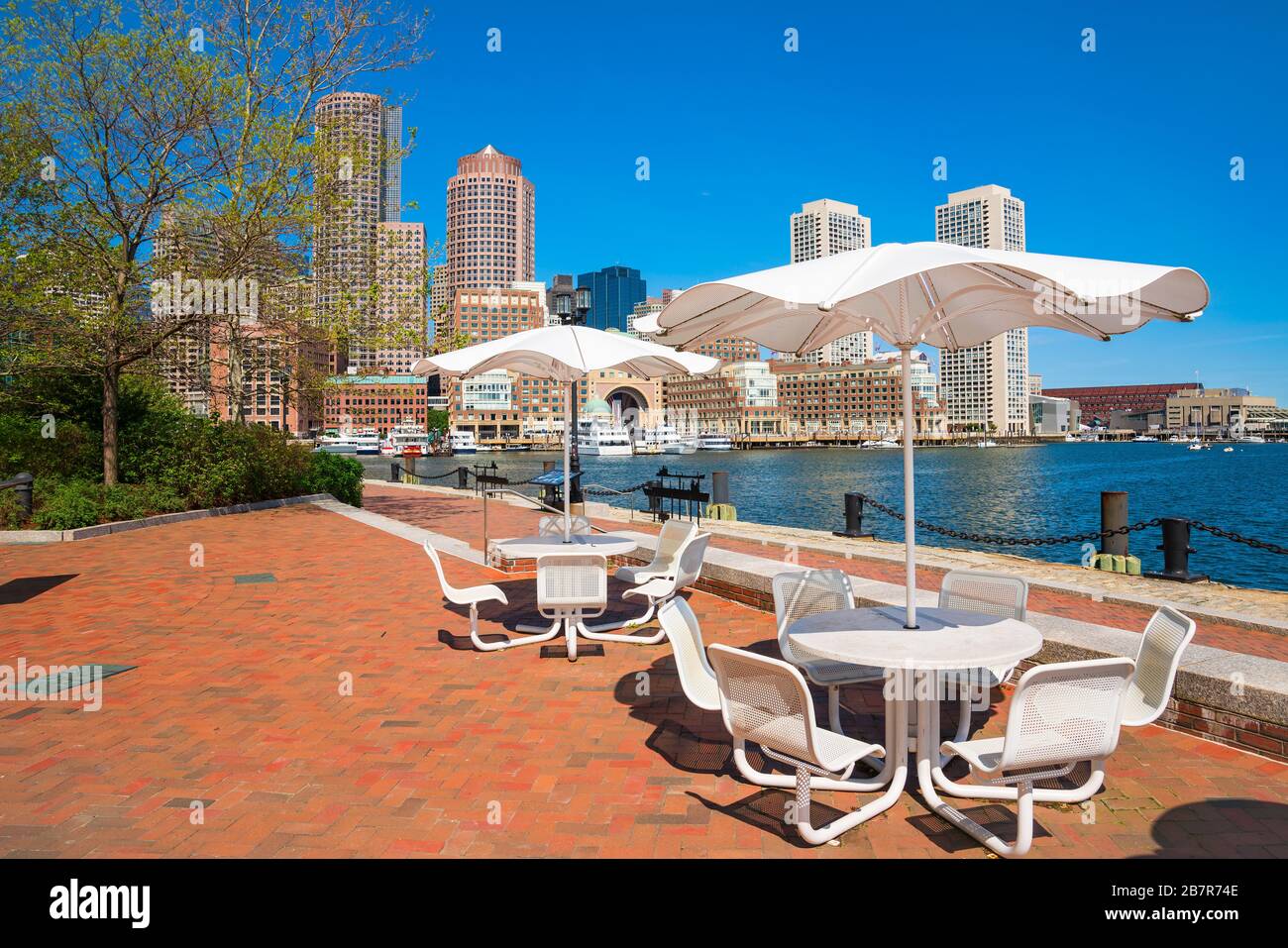 Boston harbor with chairs and umbrella Stock Photo