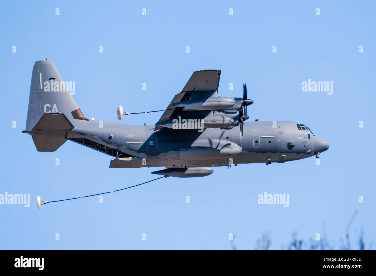 Feb 29, 2020 Mountain View / VA / USA - Lockheed Martin HC-130J Hercules military aircraft performing air refueling exercises near Moffett Federal Air Stock Photo