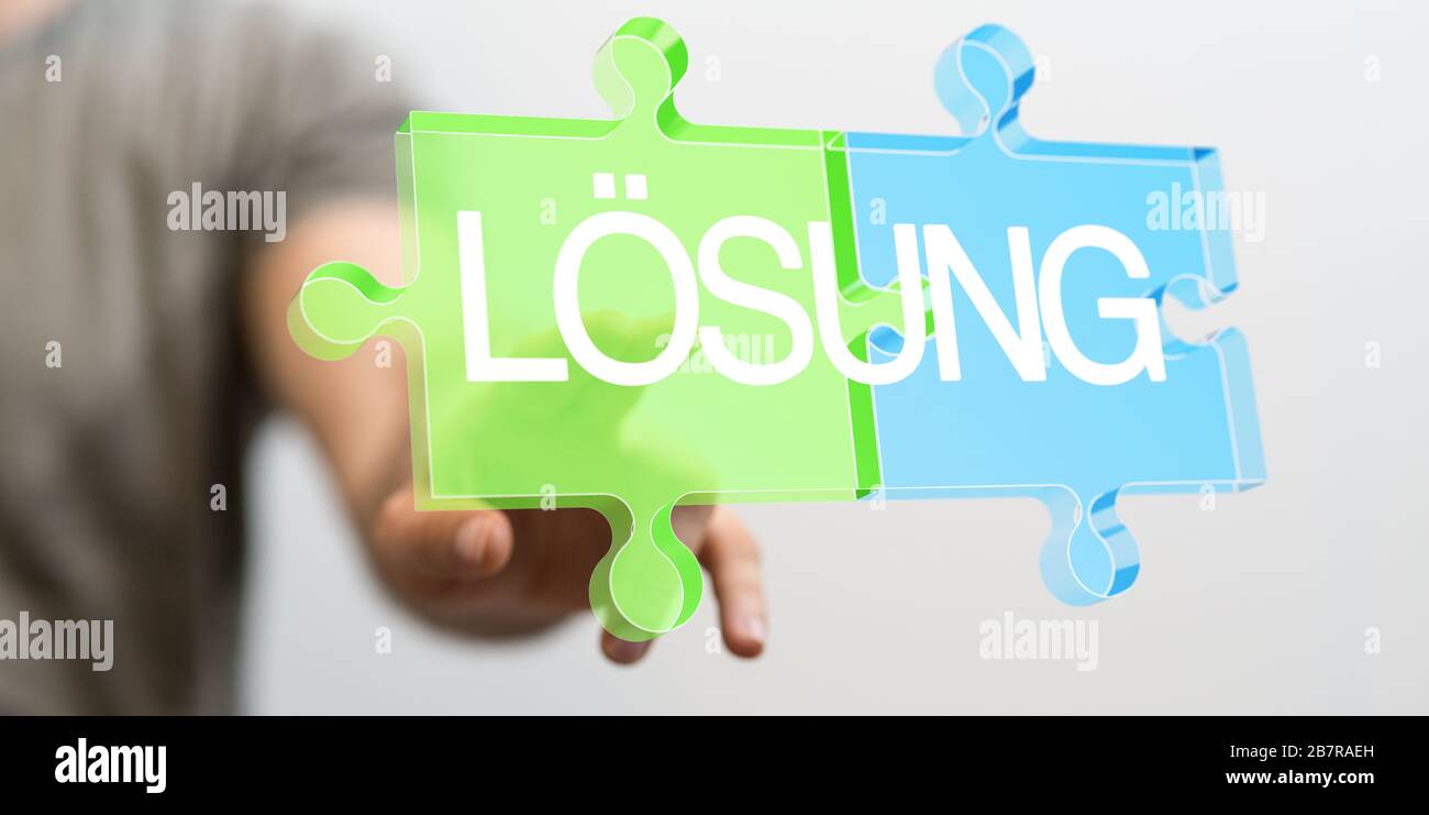 Person presenting the virtual projection of "solution" written on puzzle pieces in German Stock Photo