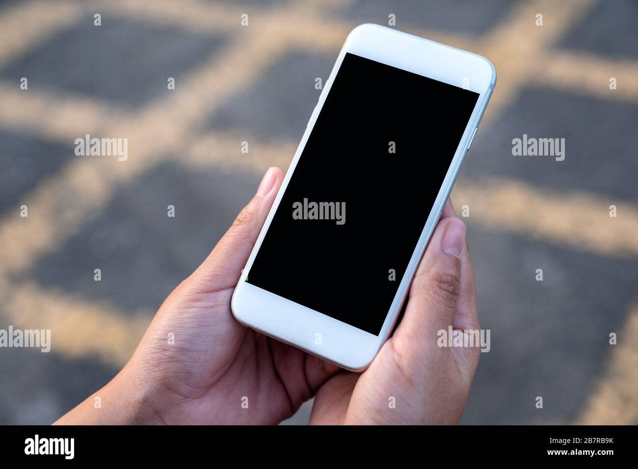 Mockup Image Of Black Hand Holding Smartphone With Blank Screen Stock Photo Alamy