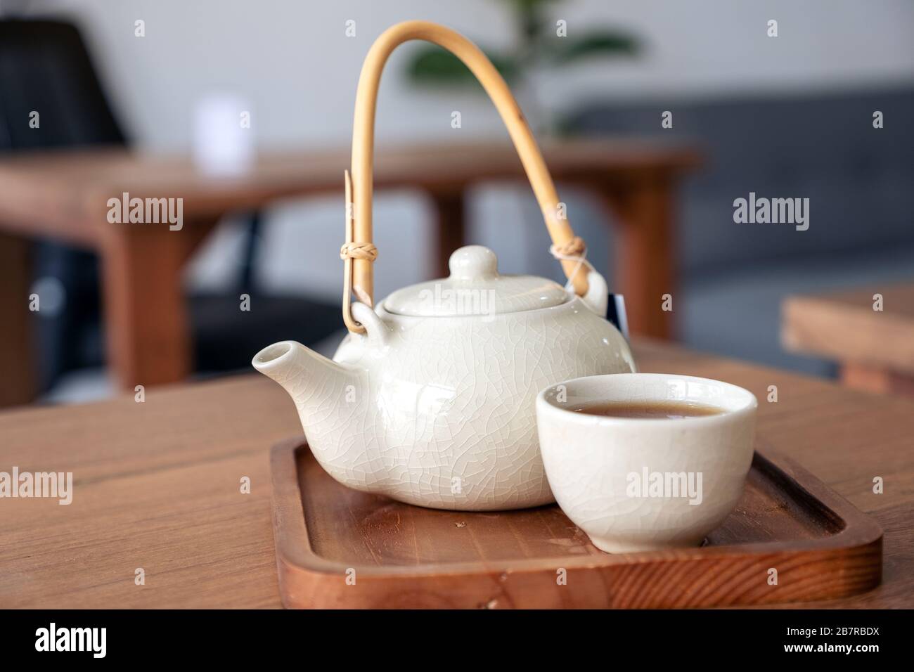 A set of ceramic japanese style teapot on wooden serving tray Stock