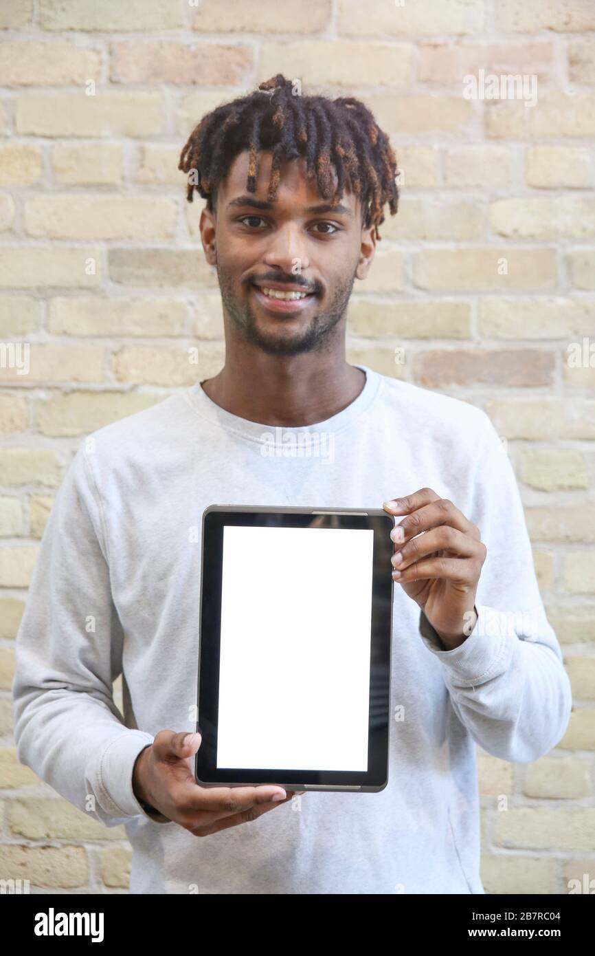 Young Man Holding a Digital Tablet Device. Isolated Screen. Stock Photo