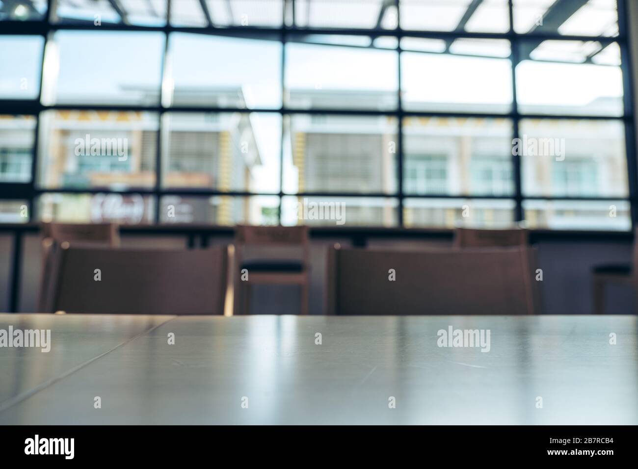 Wooden table and chairs in loft cafe Stock Photo