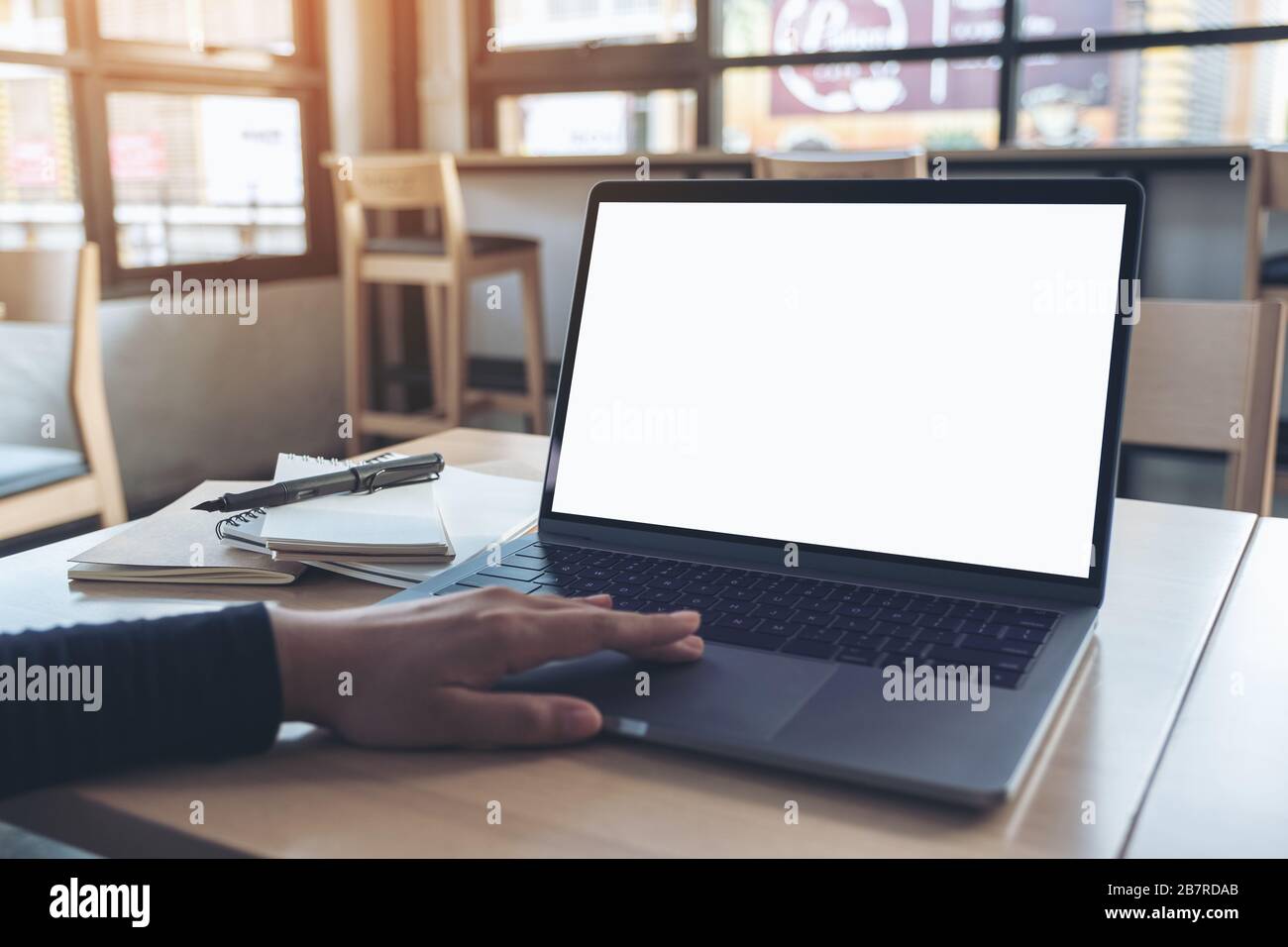 Mockup image of a hand using and touching laptop touchpad with blank ...