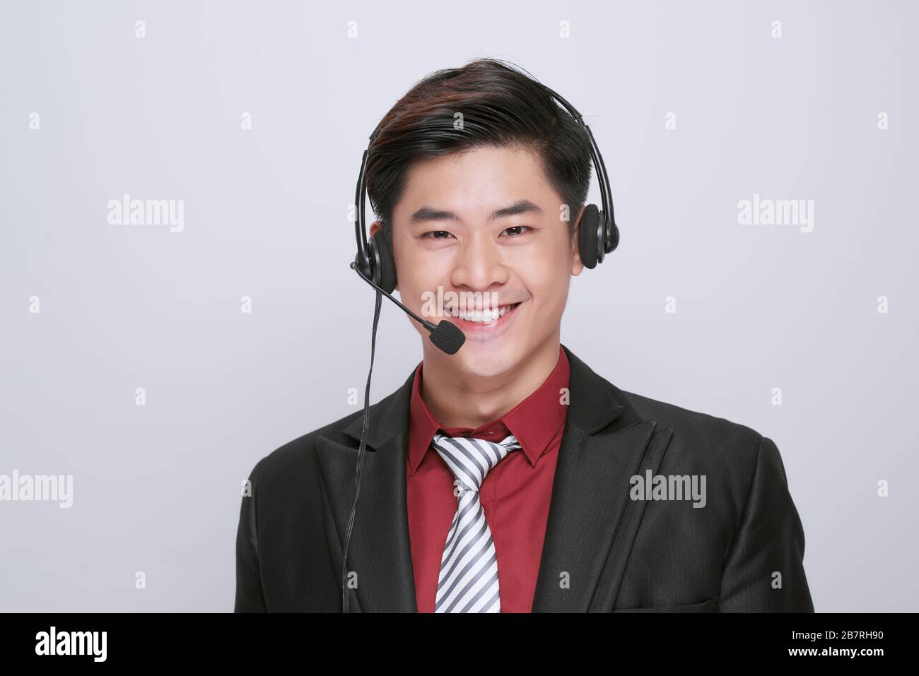 Happy young male customer support executive working isolated on white background Stock Photo
