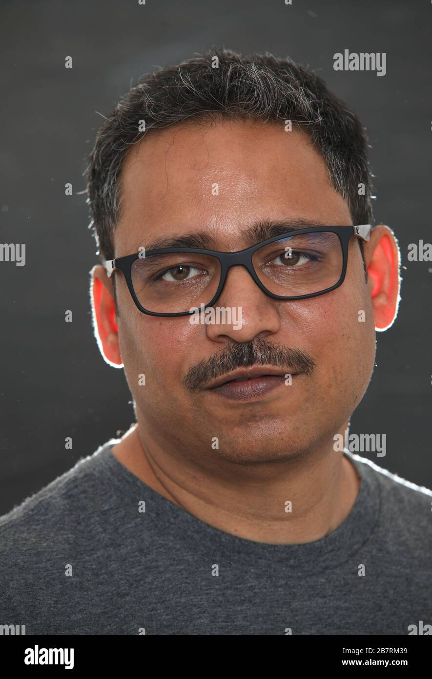 Indian man against dark background Stock Photo