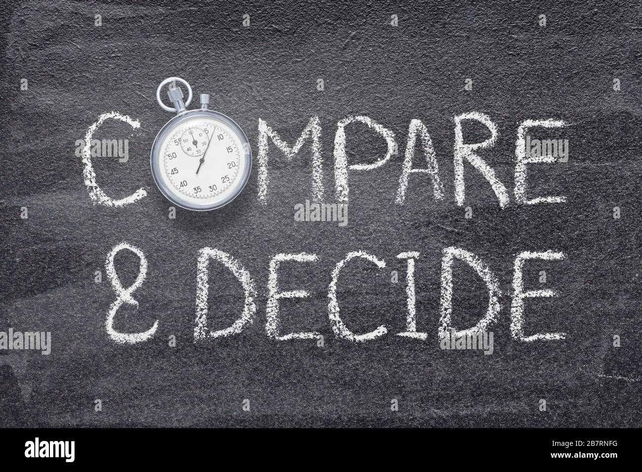 compare and decide phrase written on chalkboard with vintage precise stopwatch Stock Photo