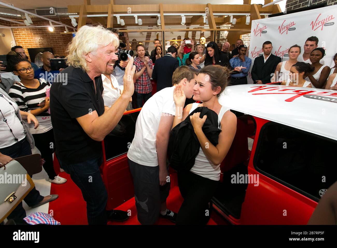 Johannesburg, South Africa - October 02, 2013: Richard Branson at Virgin Mobile Guinness World Record attempt and achieved fitting 25 people into a re Stock Photo