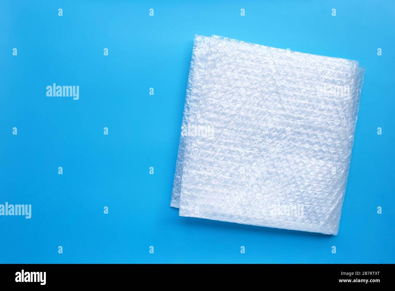 Bubble wrap on blue background. Copy space Stock Photo