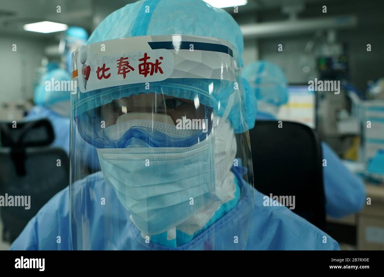 Wuhan, China's Hubei Province. 17th Mar, 2020. A nurse of the ICU (intensive care unit) stares at the monitor at the Huoshenshan (Fire God Mountain) Hospital in Wuhan, central China's Hubei Province, March 17, 2020. During the fight against the COVID-19, medical workers of the ICU of Huoshenshan Hospital work around the clock in rotations to race against time for saving the life of patients of the COVID-19 in severe and critical condition. Credit: Wang Yuguo/Xinhua/Alamy Live News Stock Photo