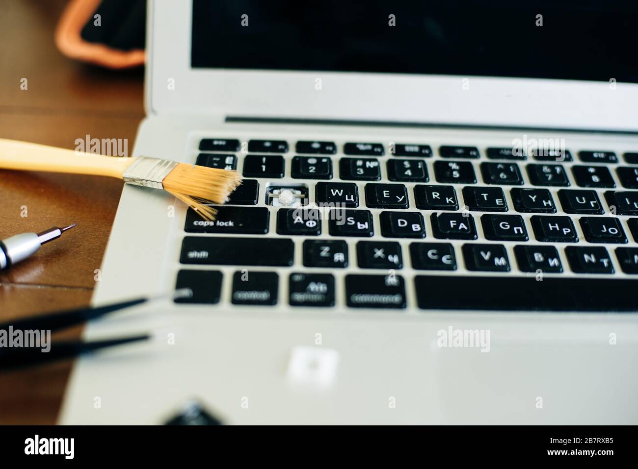 screwdriver and spare parts from a laptop. Keyboard, brush, keys