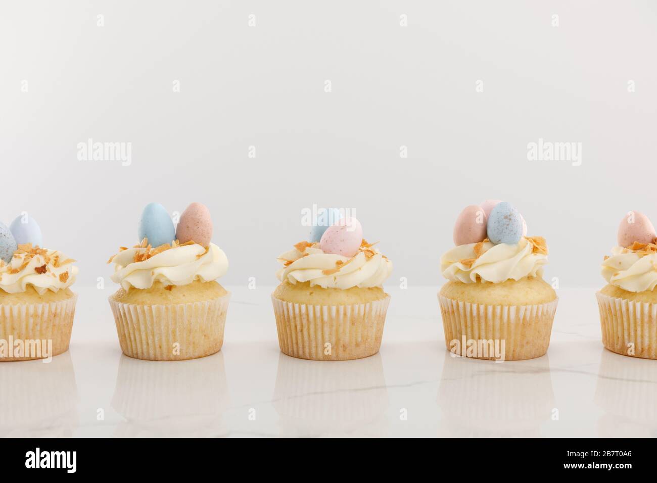 Tasty easter cupcakes isolated on grey Stock Photo