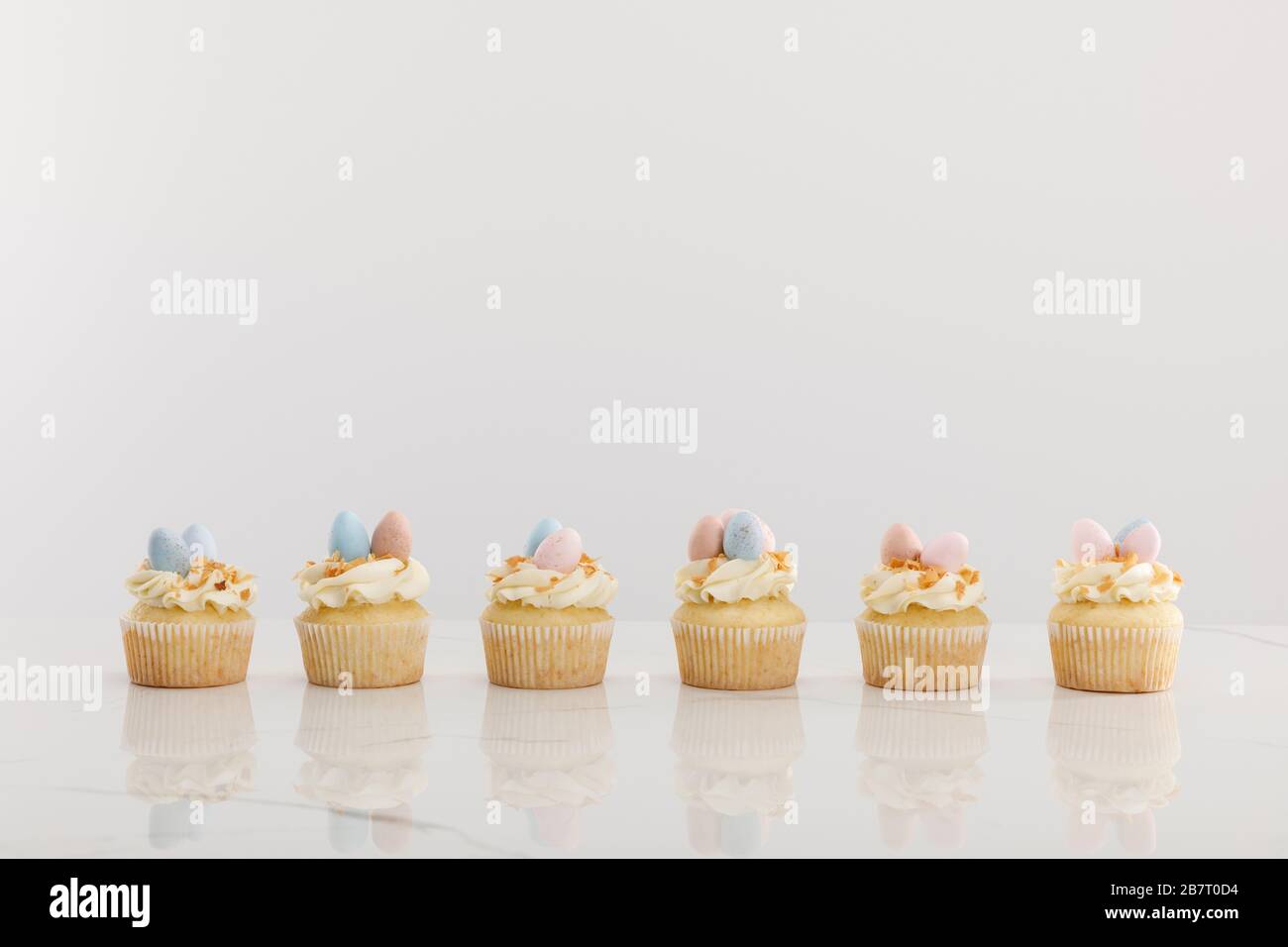 Delicious easter cupcakes isolated on grey Stock Photo