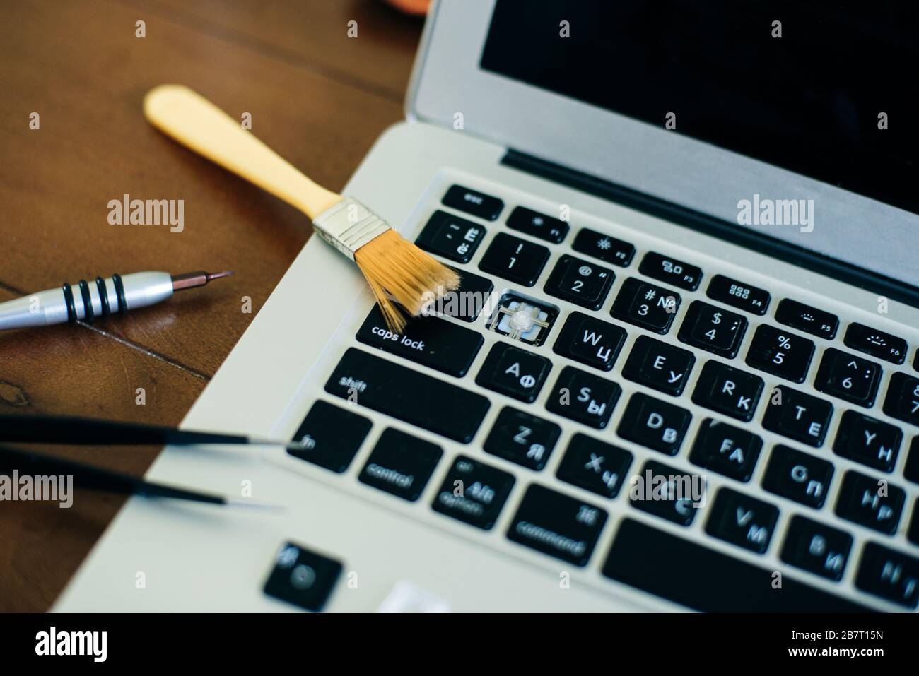 screwdriver and spare parts from a laptop. Keyboard, brush, keys