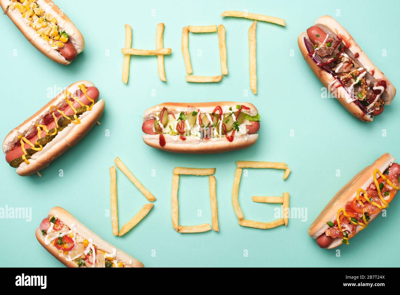 top view of unhealthy hot dogs on blue with word hot dog made from