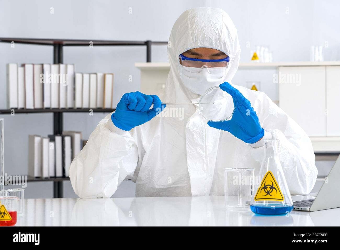 Coronavirus disease 2019 (COVID-19) testing process in a laboratory preventing the spread of viral research. Stock Photo