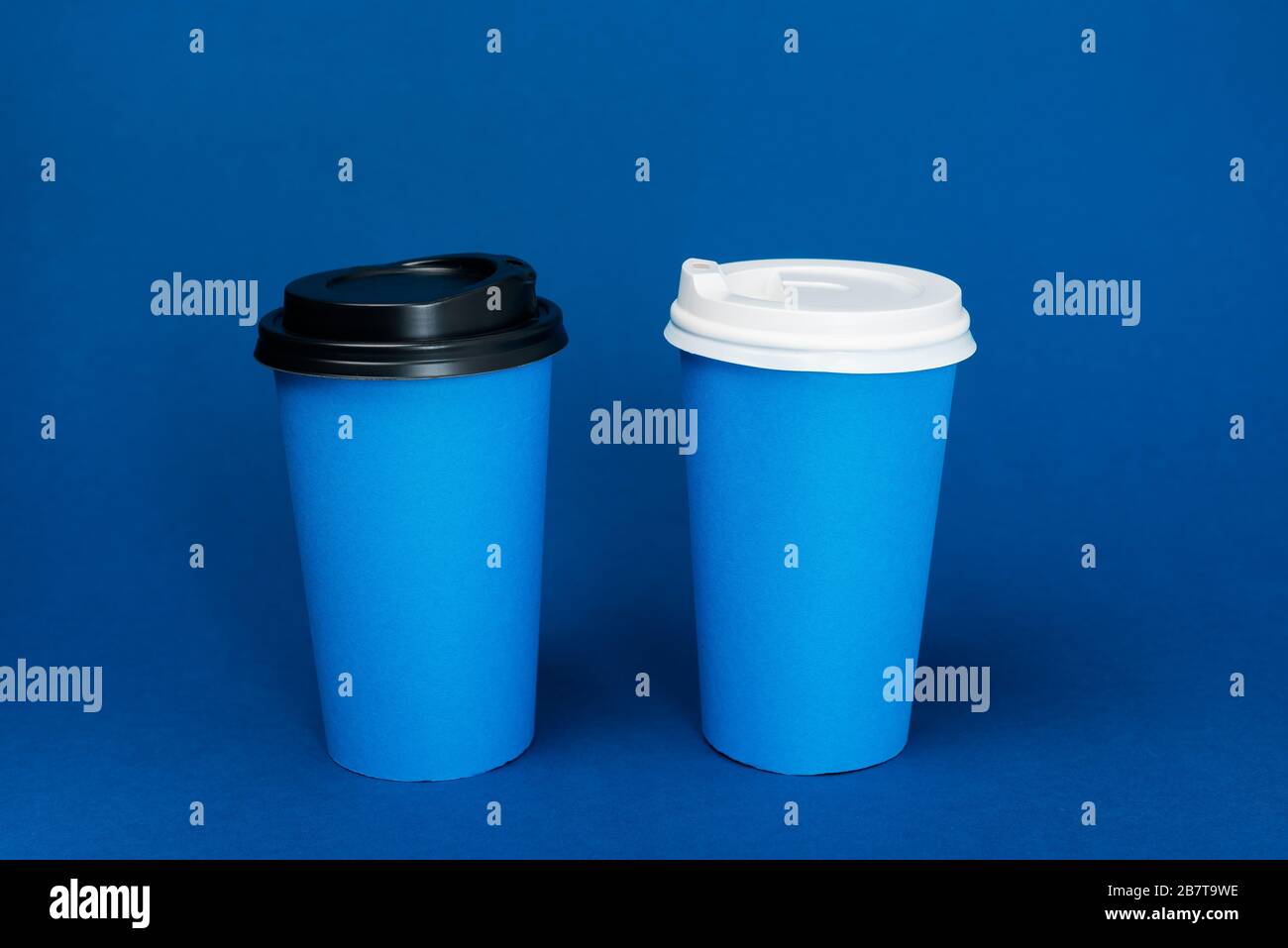 paper cups with coffee on classic blue background Stock Photo - Alamy