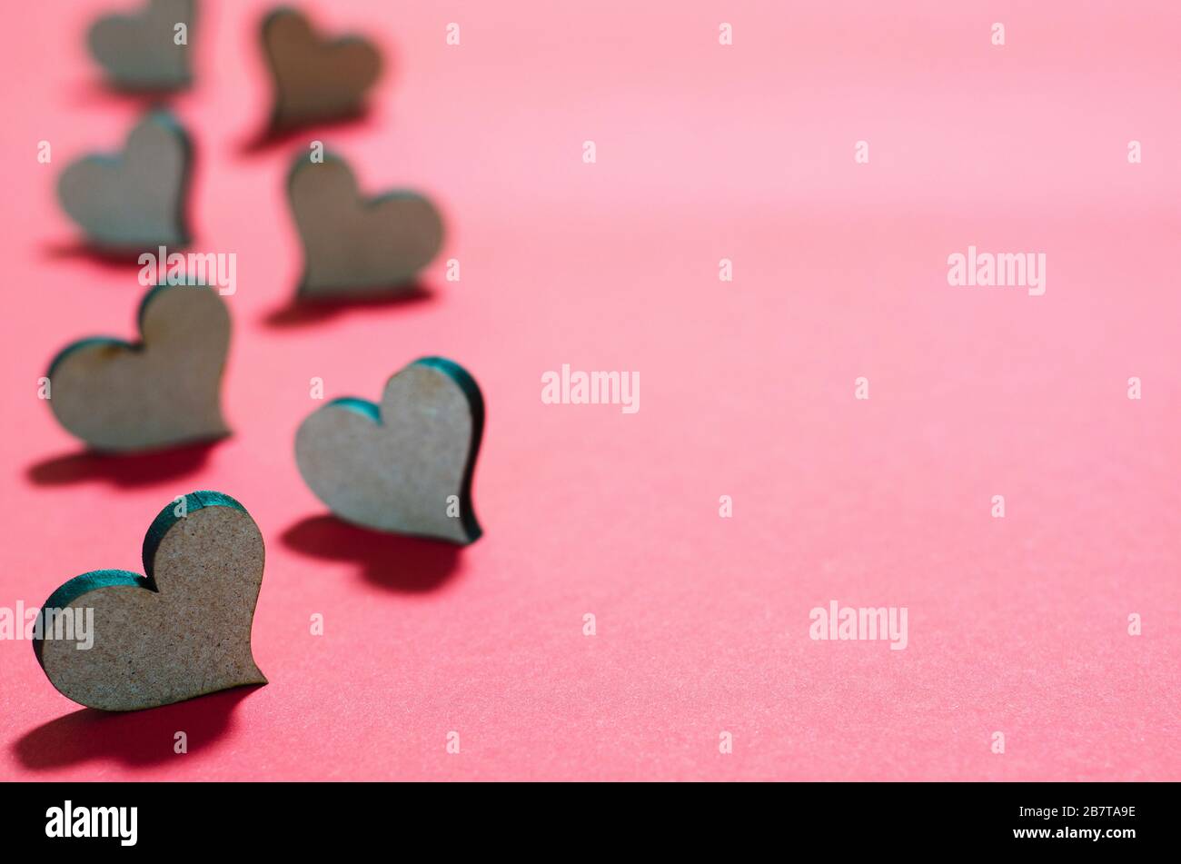wooden hearts on a red background 2 Stock Photo - Alamy