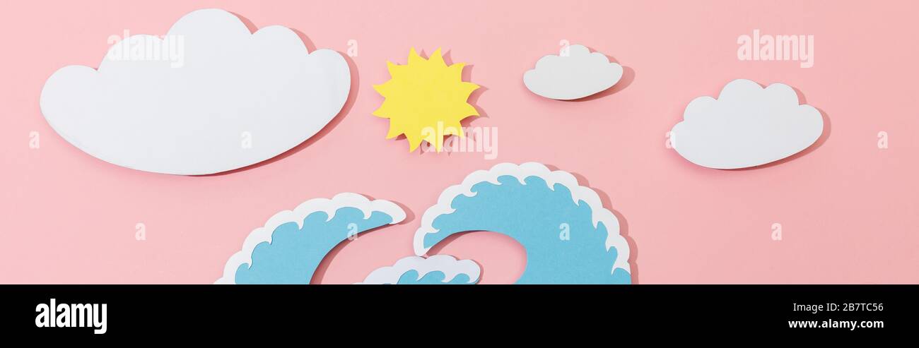 Top view of paper cut sea waves, clouds and sun on pink background ...