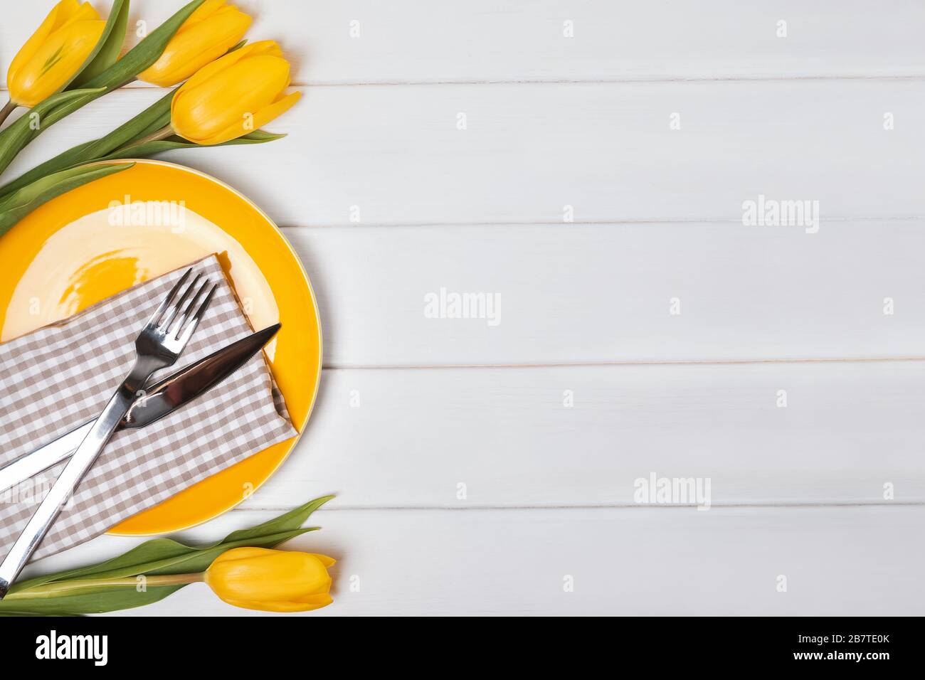 Festive table with yellow tulips. Stock Photo