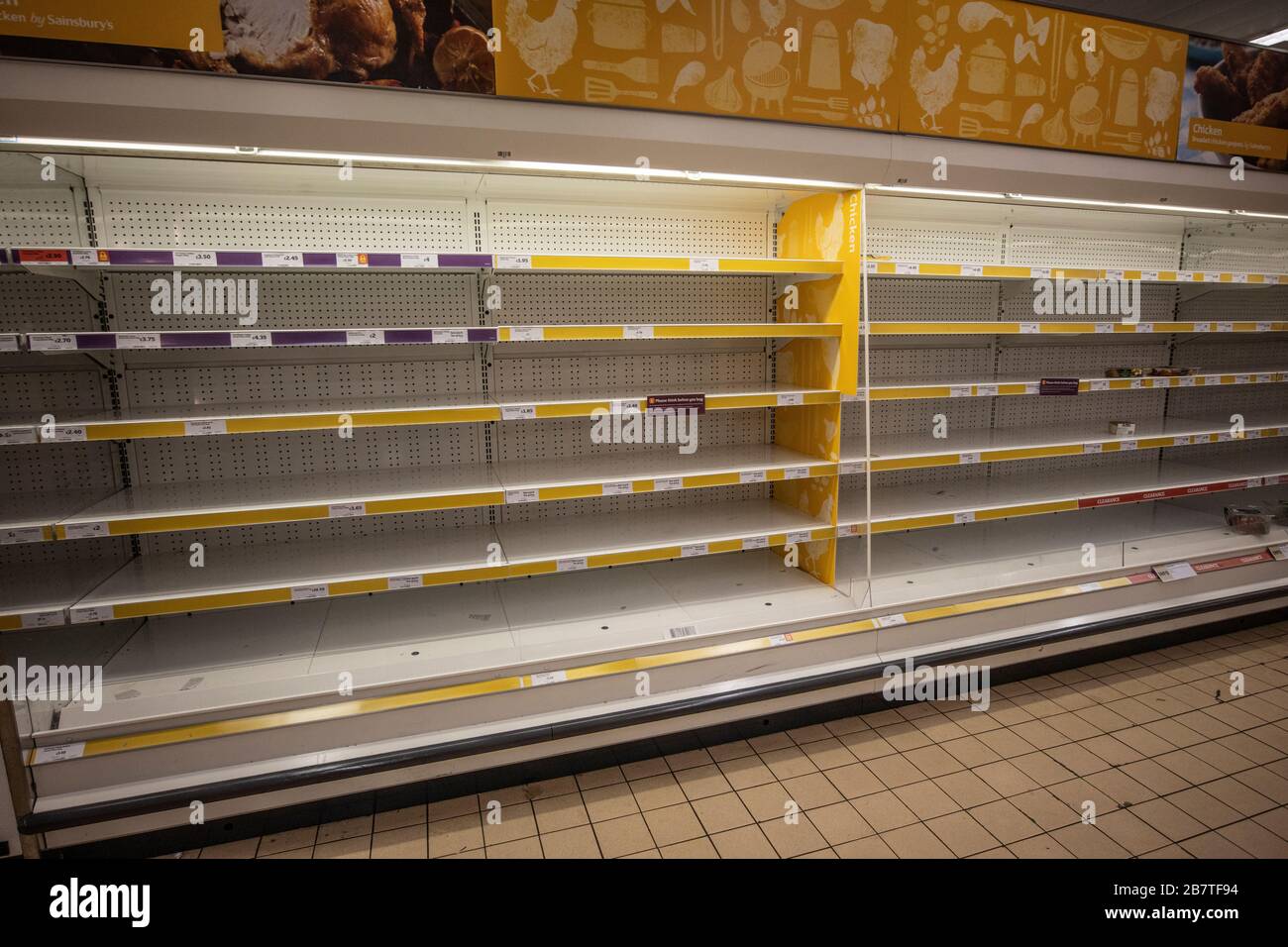 Empty shelves in a supermarket which usually contain fresh meat and