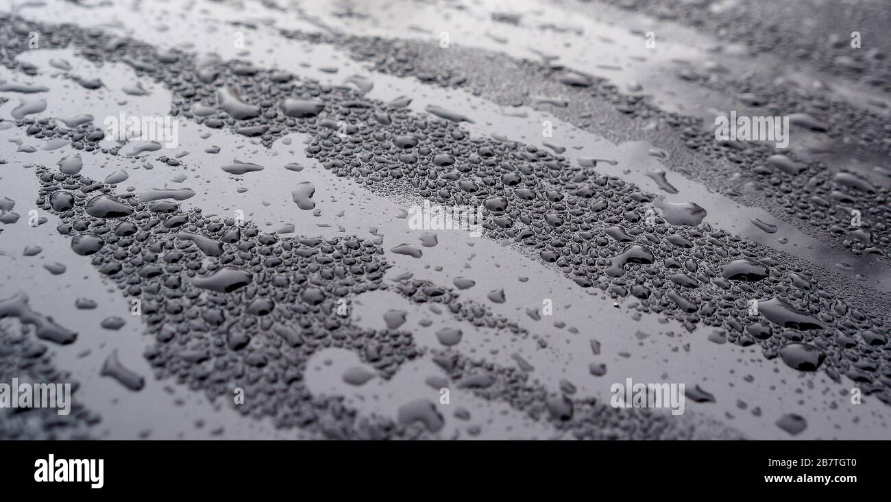 Rain drops on glass and metal, condensation drops abstract background and texture. Stock Photo