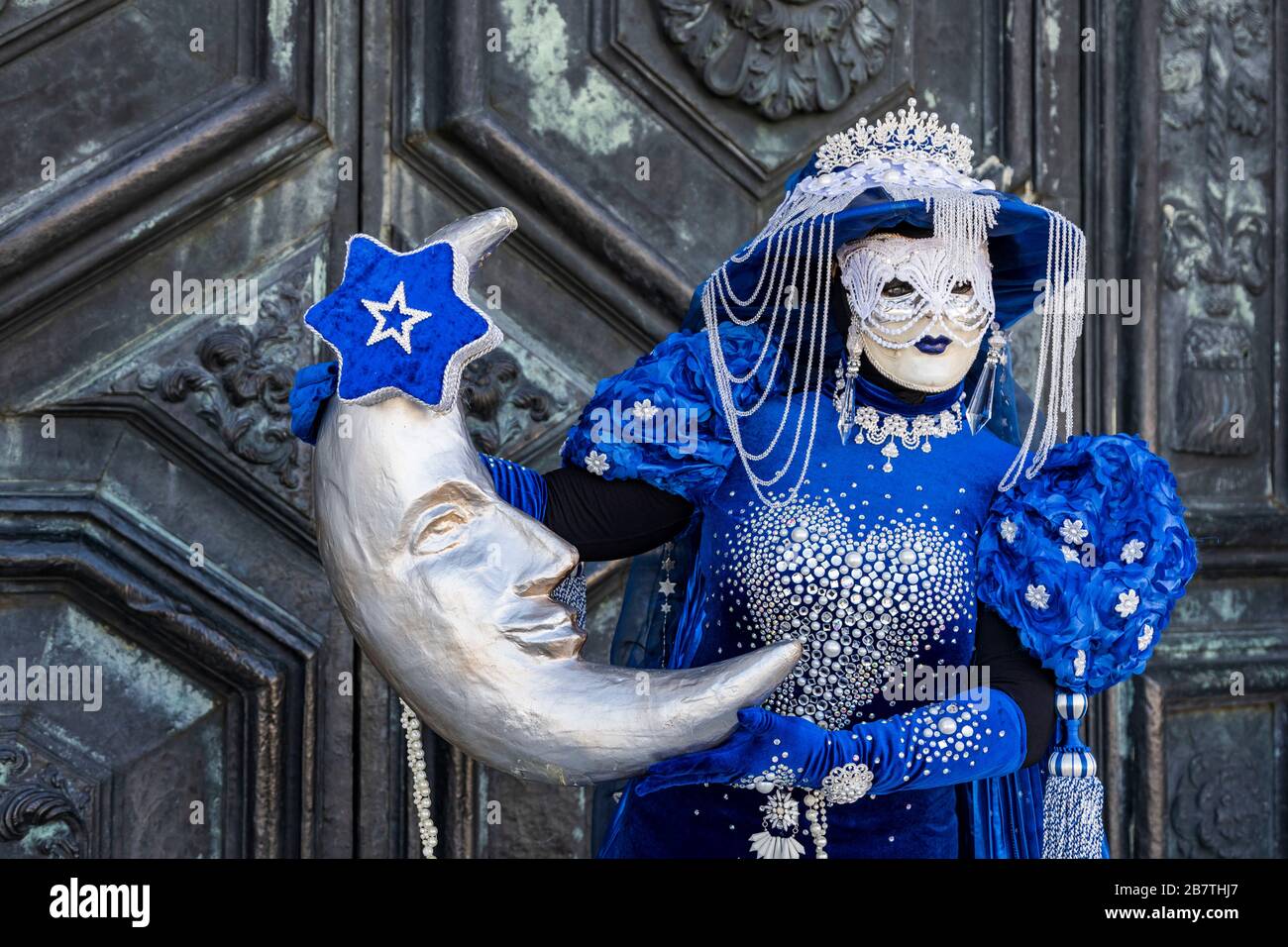 Woman wearing a mask holding a large crescent shaped moon during the  Carnival in Venice, Venice, Veneto, Italy, Europe Stock Photo - Alamy