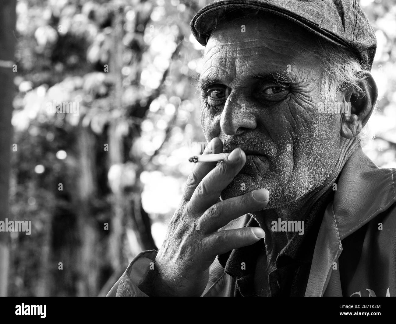 Old coal miner having a wine and cigarette break in Chiatura, Georgia Stock Photo