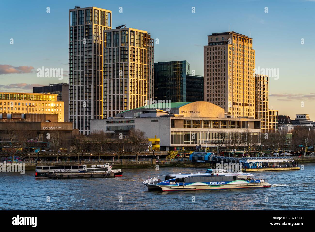 A Thames Clipper River Bus passes the Royal Festival Hall and Southbank Place Development on London's Southbank. Stock Photo