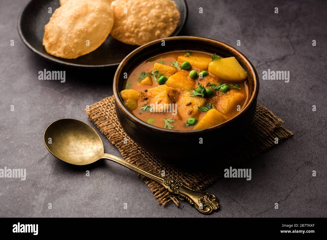 Aloo Puri or Potato curry with fried Poori, popular Indian breakfast
