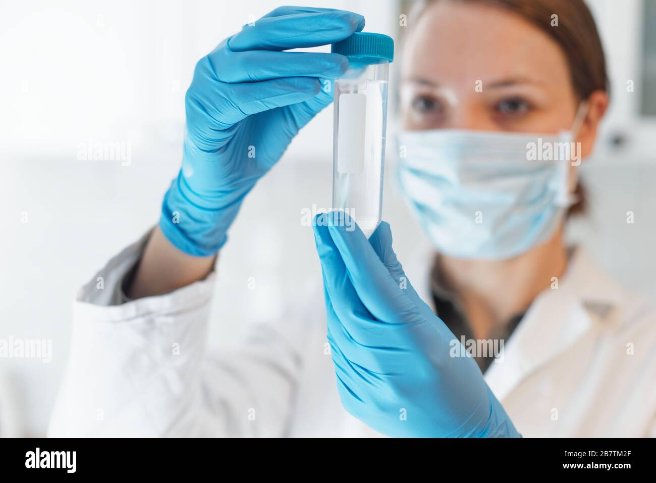 Female Scientist Medical Research Lab researching test tubes in laboratory Stock Photo