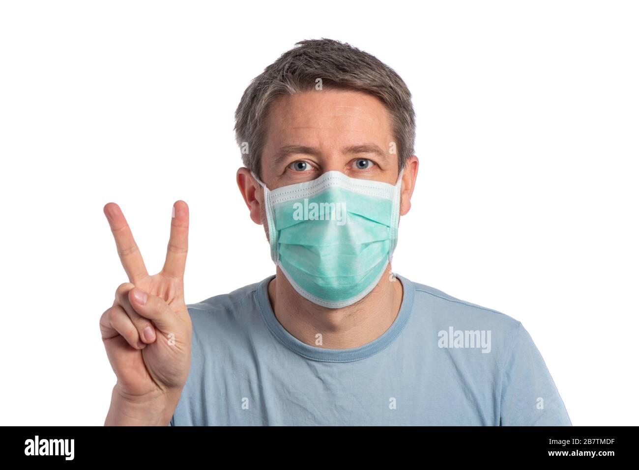 Caucasian man wearing a protection mask and making vistory sign with protective gloves on a white background Stock Photo