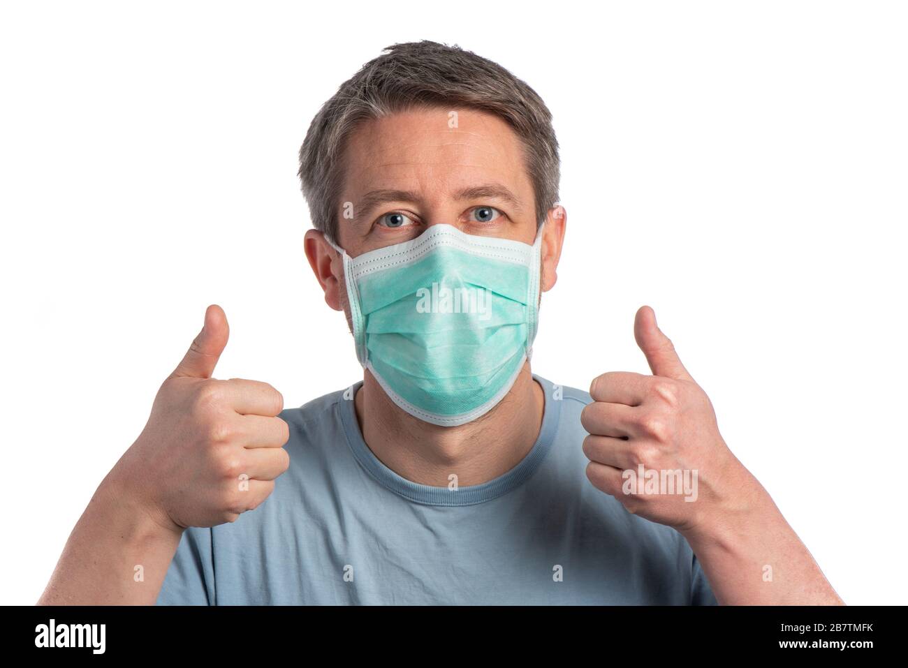 Caucasian man wearing a protection mask and making vistory sign with protective gloves on a white background Stock Photo