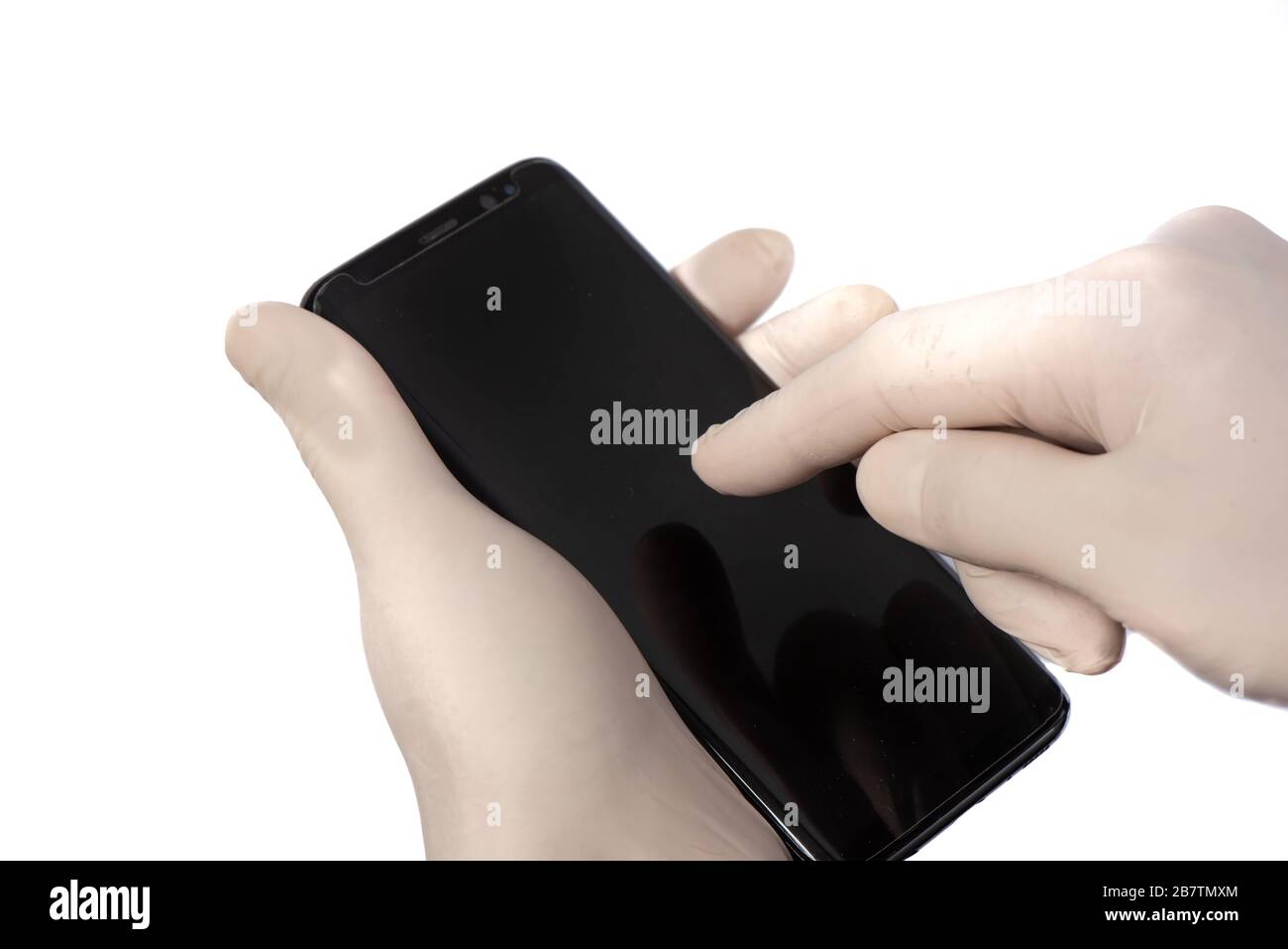 Using a cell phone with white protective gloves Stock Photo