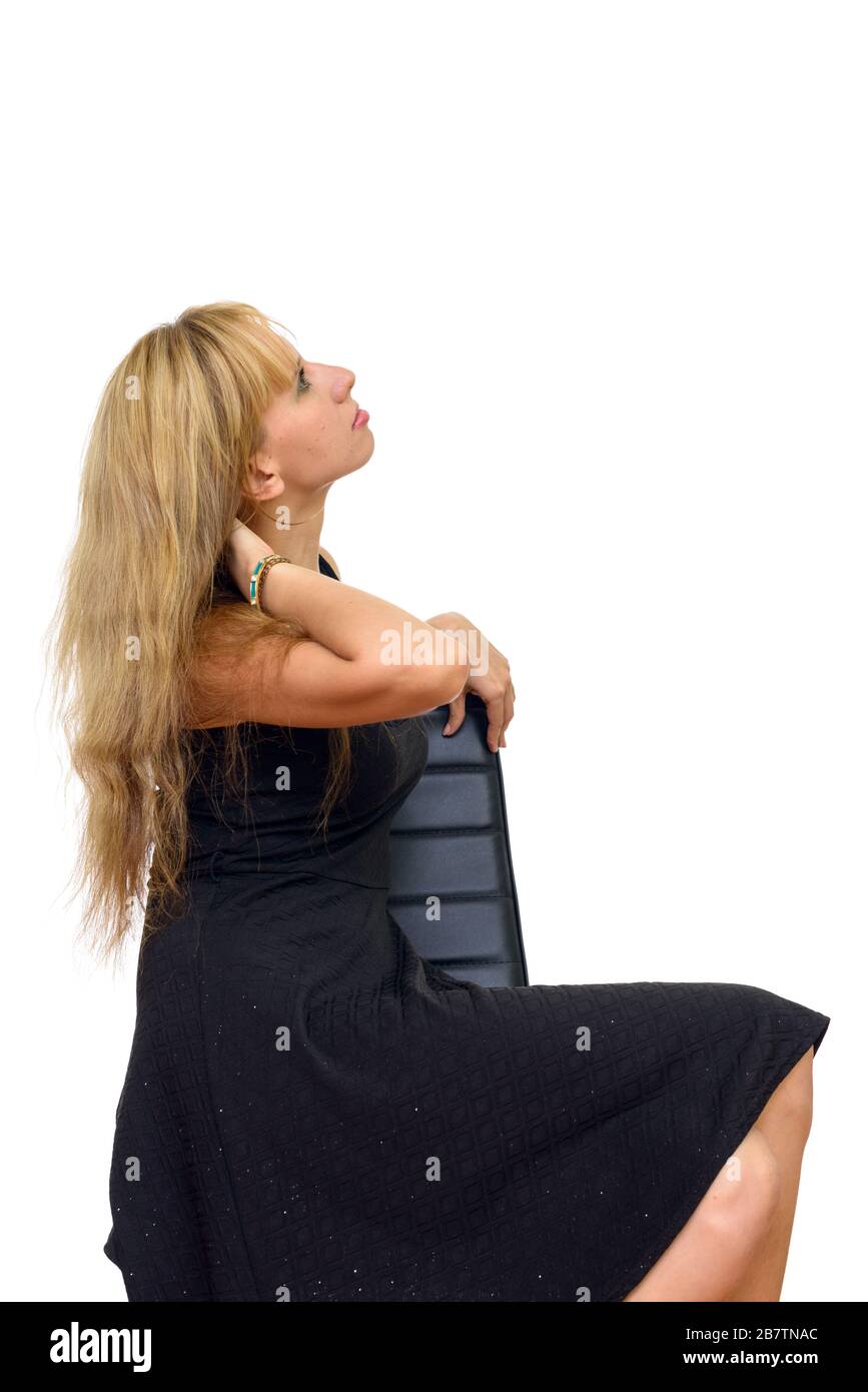 Profile view of beautiful blonde businesswoman sitting on chair Stock Photo