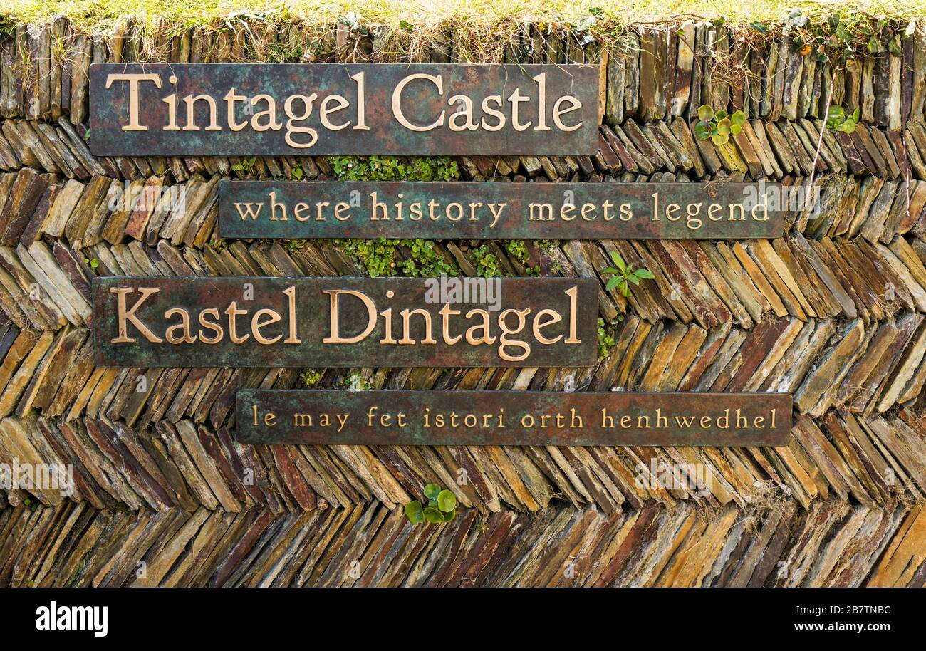 Entrance signs on a traditional Cornish slate wall at Tintagel Castle, linked to the legend of King Arthur, Tintagel, Cornwall, UK. Stock Photo