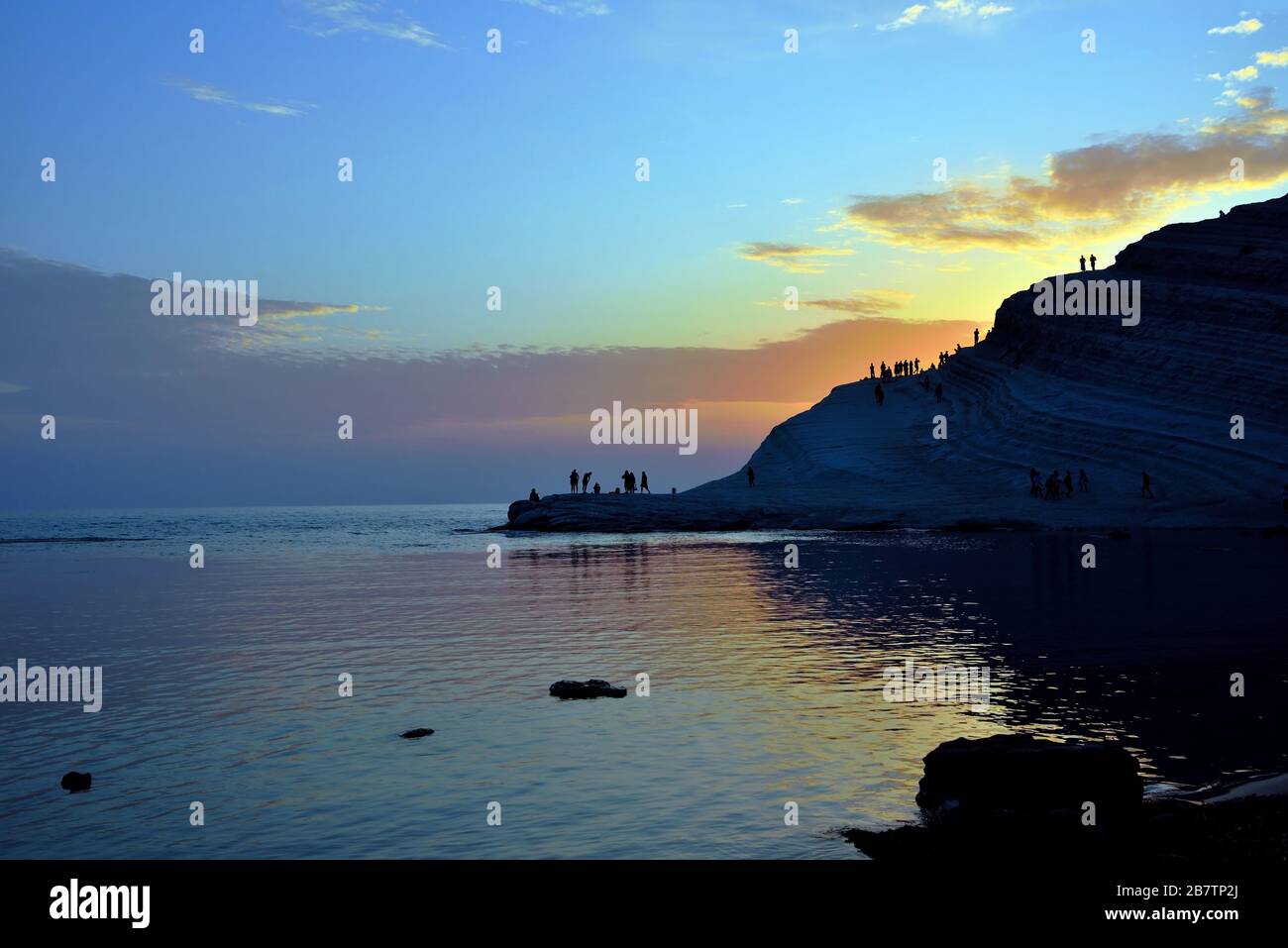Tourists Watching The Sunset And Enjoying The Sea At The Scala Dei tourists-watching-the-sunset-and-enjoying-the-sea-at-the-scala-dei