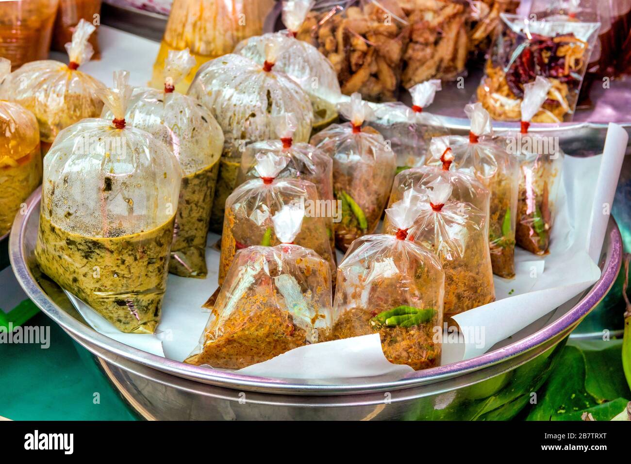 Traditional thai sauces sold in plastic bags Stock Photo