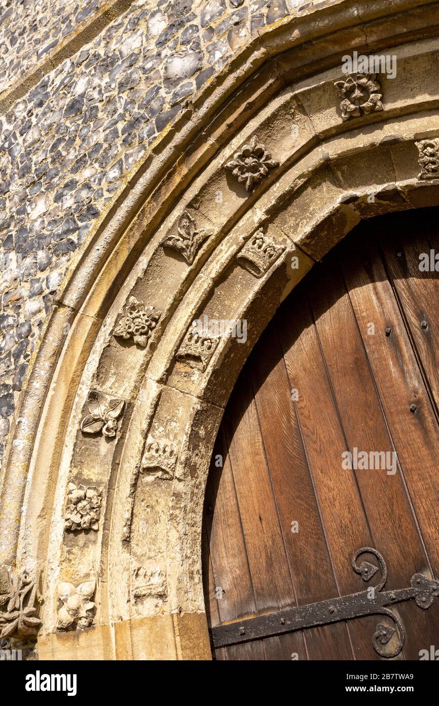 Historic village parish church at Kenton, Suffolk, England, UK stone doorway arch carved stonework detail casement mouldings Stock Photo