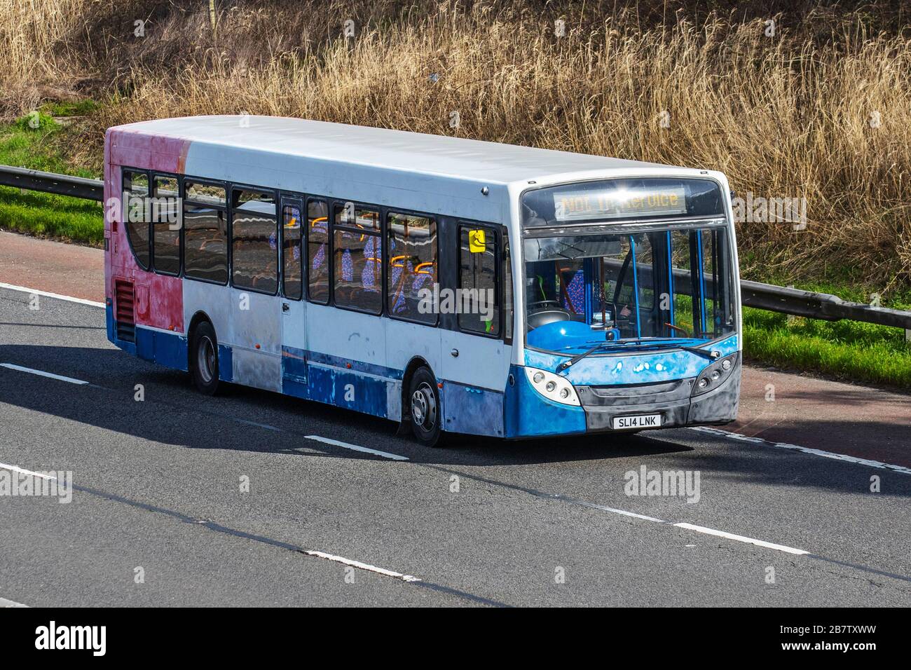 SL14LNK multi-coloured Alexander Dennis Enviro; barn find vehicle restoration project. UK Vehicular traffic derelict condition, old collectible vintage classic transport, single decker old bus, veteran classics on the 3 lane M6 Motorway highway. Stock Photo