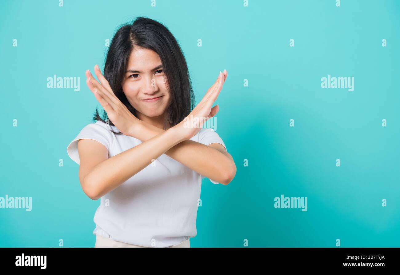 Portrait Happy Asian Beautiful Young Woman Unhappy Or Confident Standing Wear White T Shirt She Holding Two Crossing Arms Say No X Sign Studio Shot Stock Photo Alamy