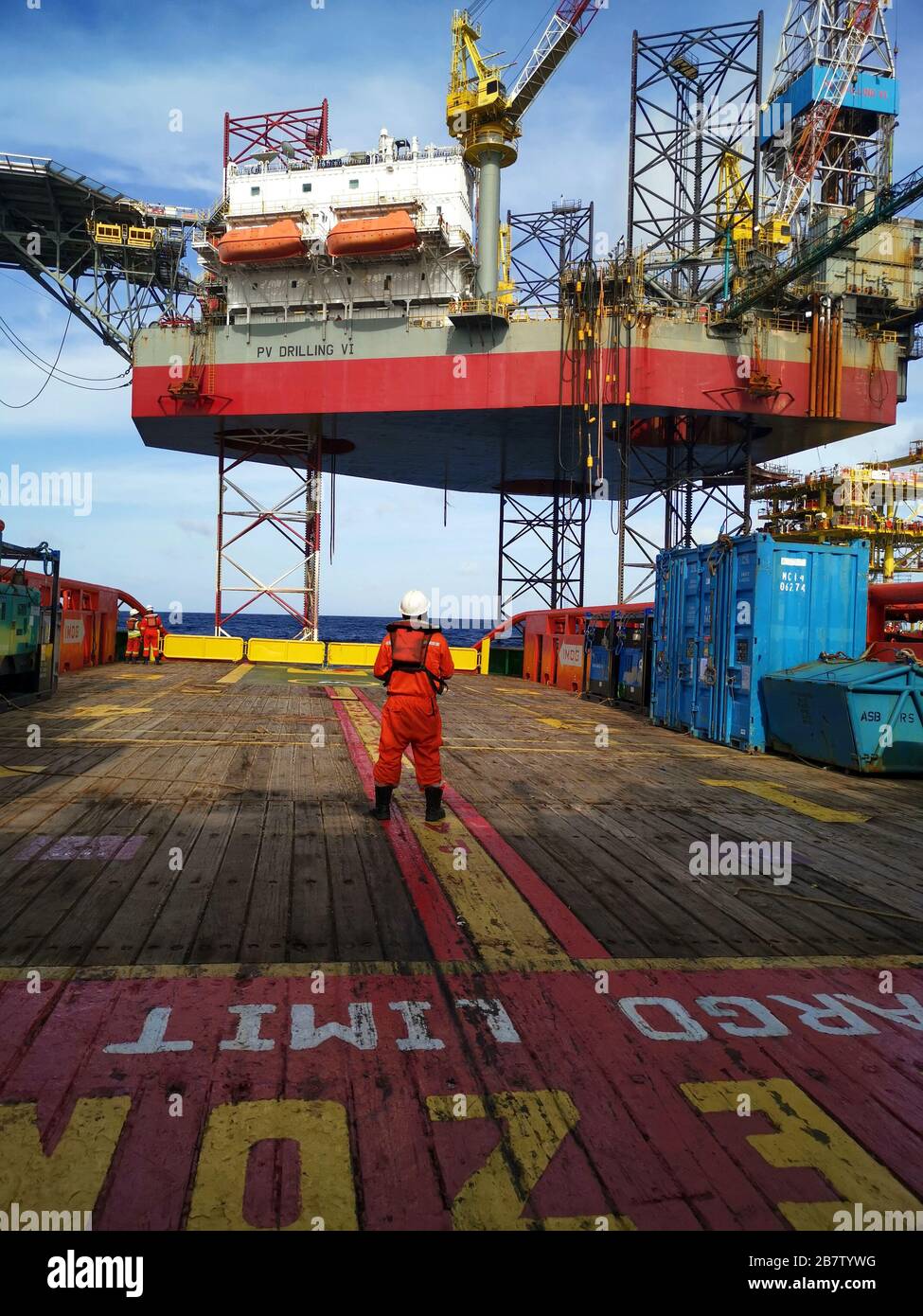 marine crew stand by on deck to received cargo from oil rig Stock Photo