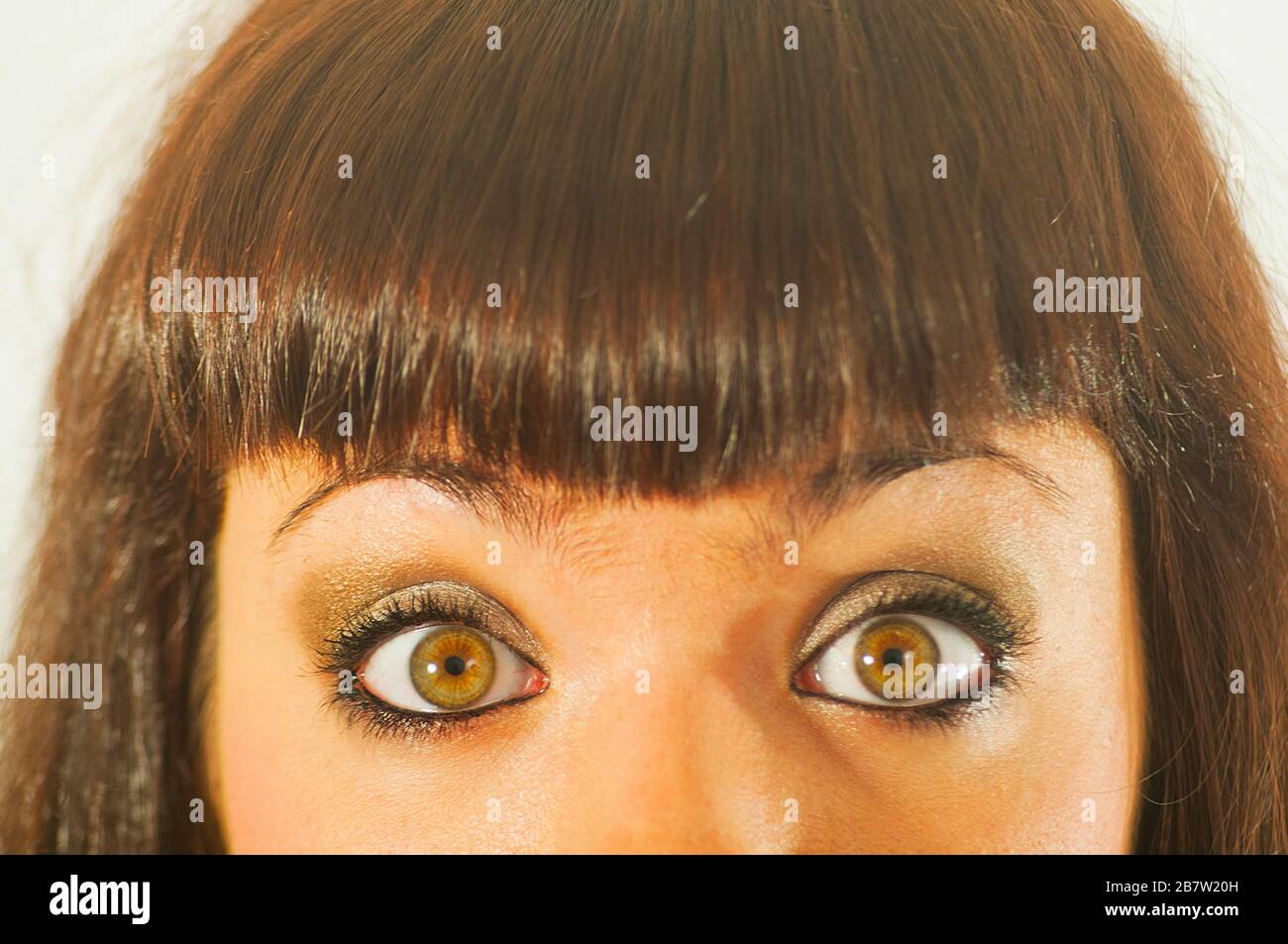 Young woman's eyes expressing surprise. Close view. Stock Photo