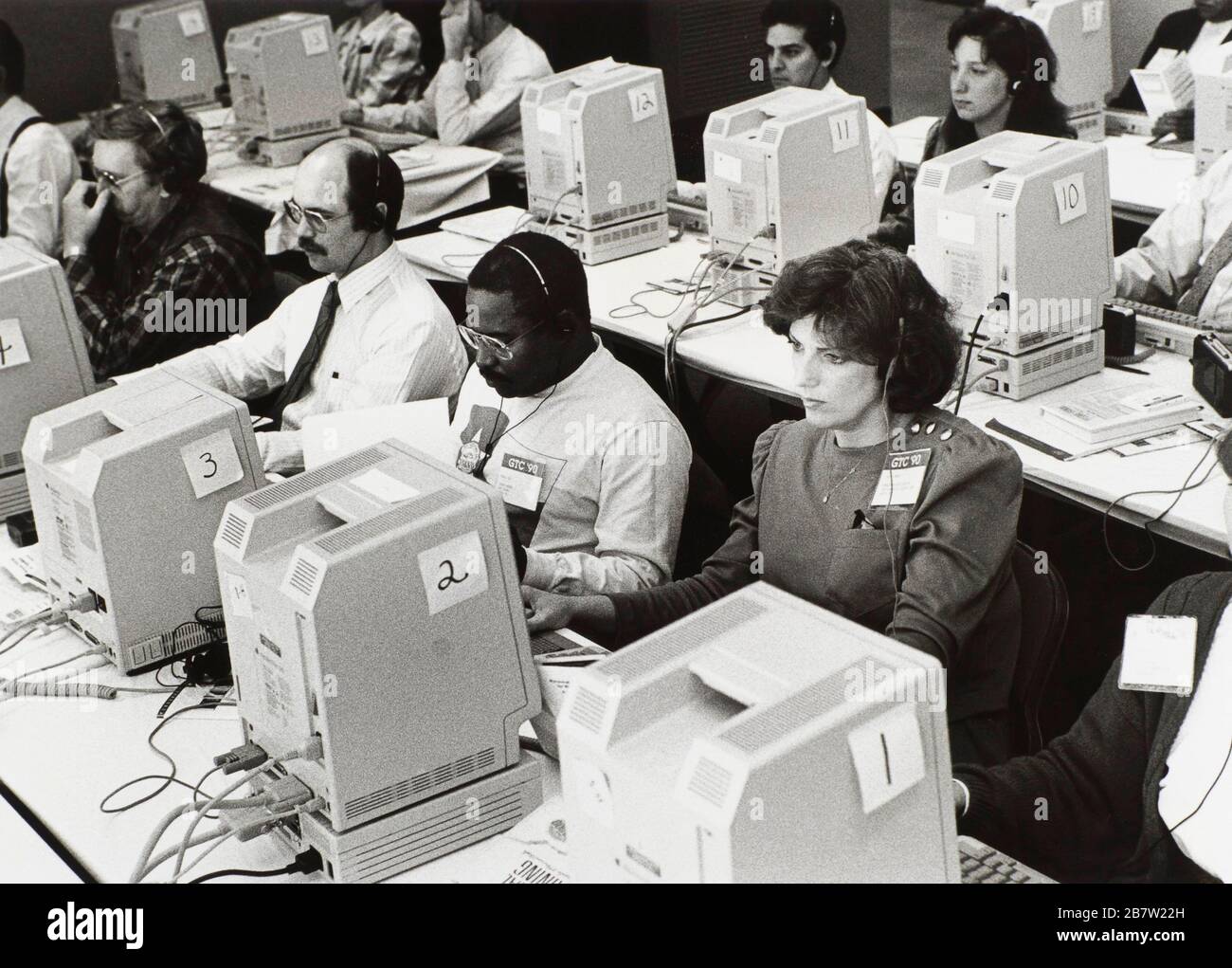 Austin, Texas USA, 1981: A group of adults use headphones to listen to instructions during computer training class. ©Bob Daemmrich Stock Photo