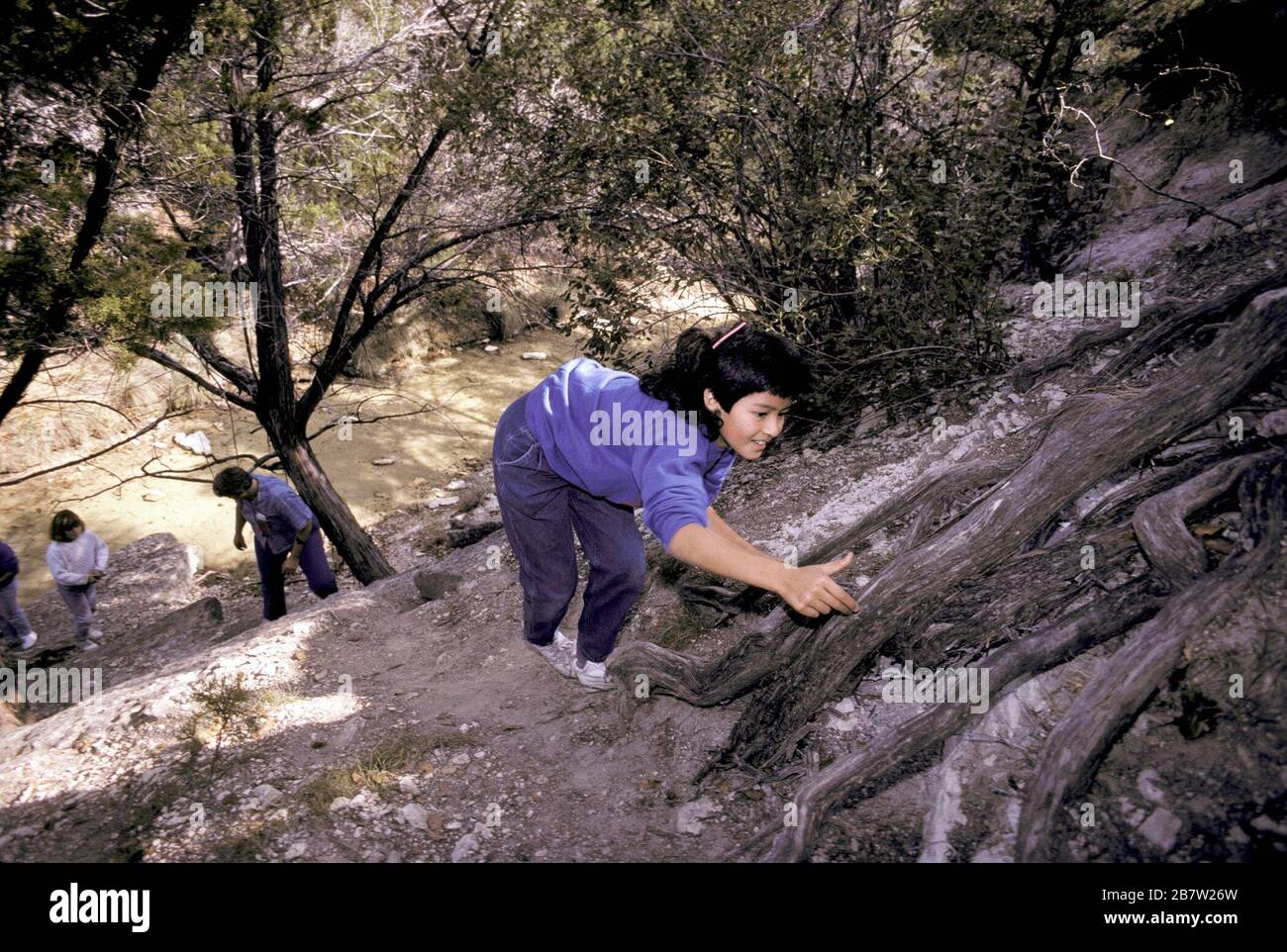 Texas: Fourth grade students on overnight school field trip to the Texas Hill Country hike up a steep hill. ©Bob Daemmrich Stock Photo