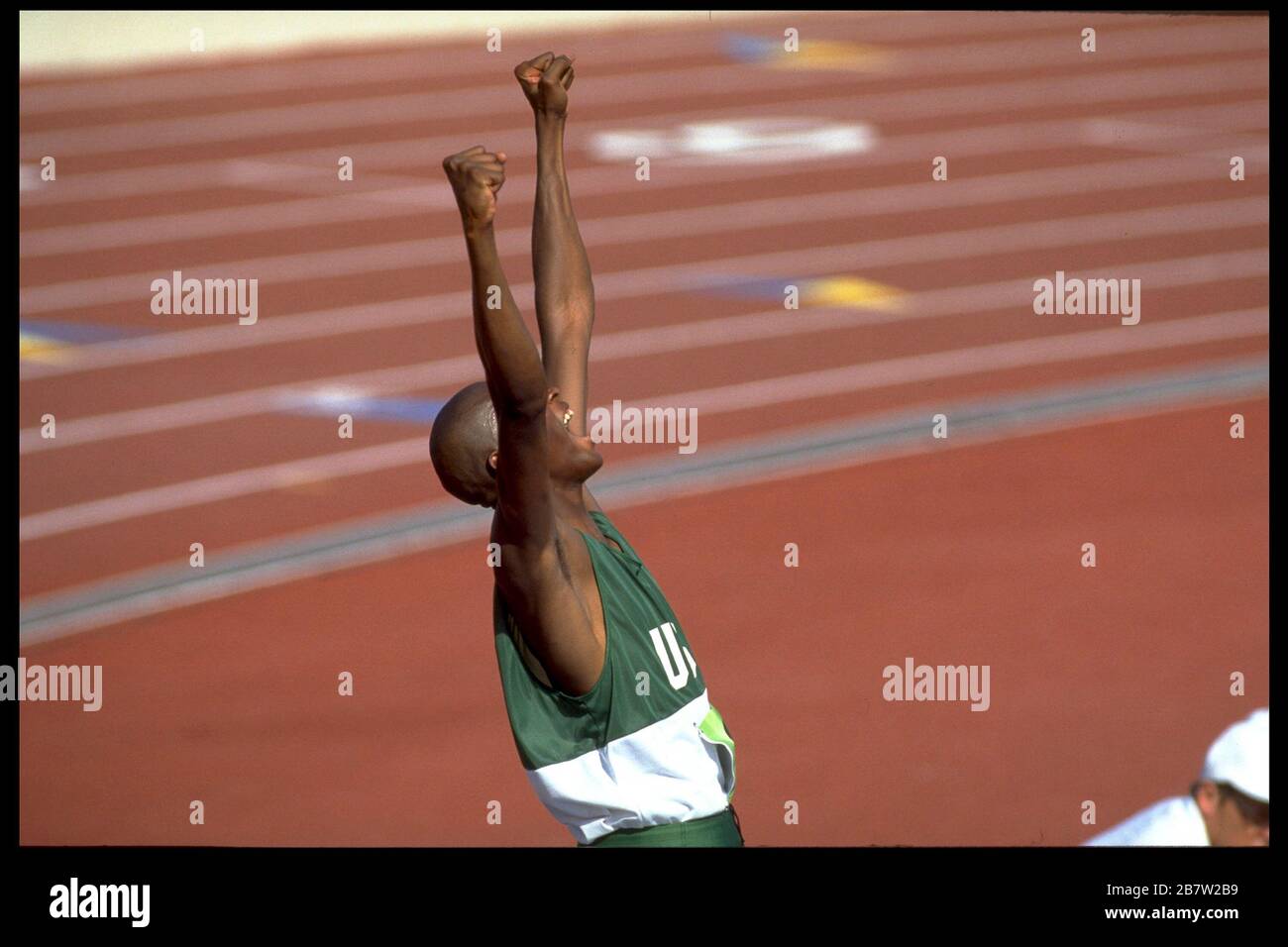 Young Black athlete celebrates after clearing bar in men's high jump