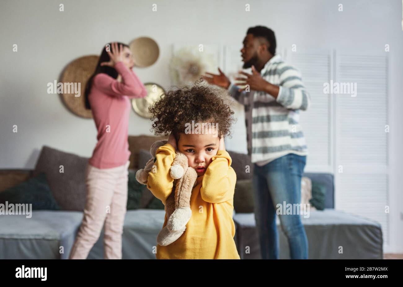 Focus on little daughter, covering her ears Stock Photo