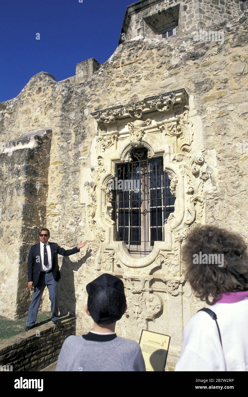 San Antonio Texas USA: Tour guide points out The Rose Window on south facade of Mission San Jose. ©Bob Daemmrich Stock Photo